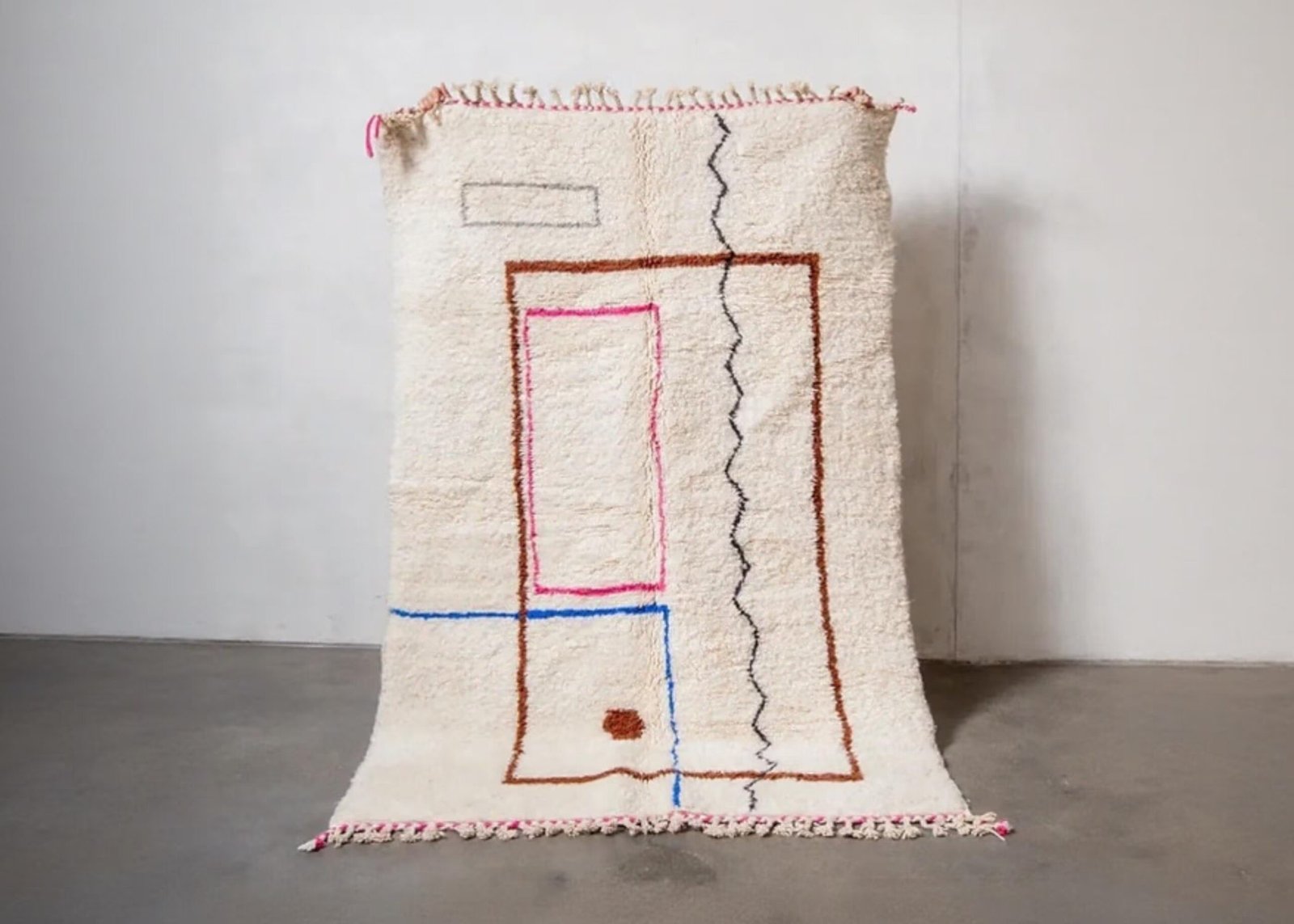 Berber Teppich aus Marokko mit rosa und blauen Linien auf cremeweißem Hintergrund